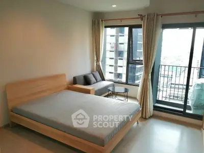 Modern bedroom with large windows and balcony in urban apartment