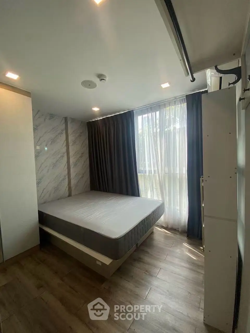 Modern bedroom with large window and elegant decor