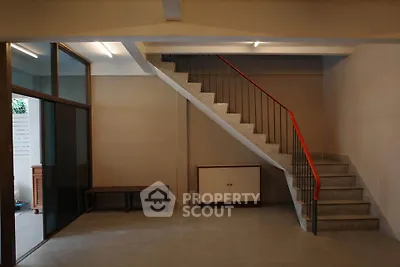 Spacious interior with modern staircase and glass partition, ideal for stylish urban living.