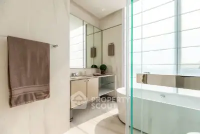 Luxurious bathroom with modern design and elegant bathtub in bright natural light.