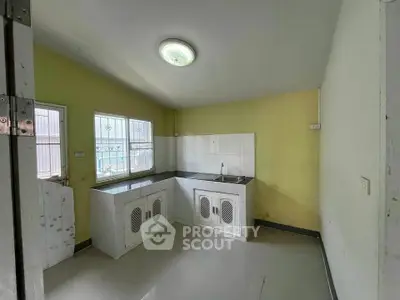 Spacious kitchen with closed layout and ample natural light