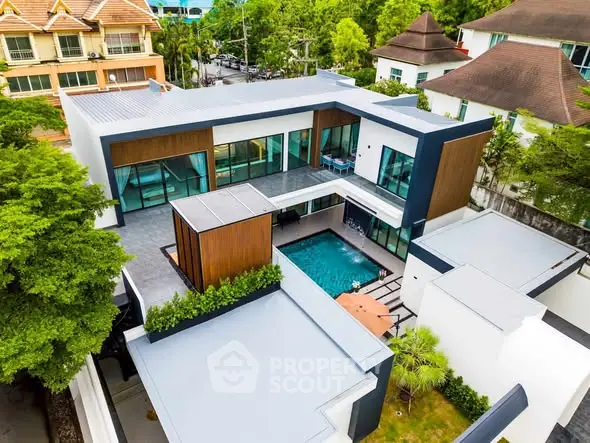 Stunning modern villa with pool and lush greenery, perfect for luxury living.