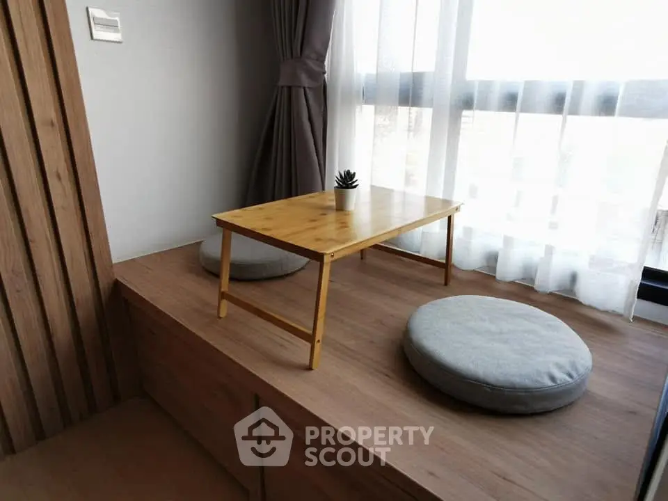 Cozy minimalist living space with wooden platform and natural light