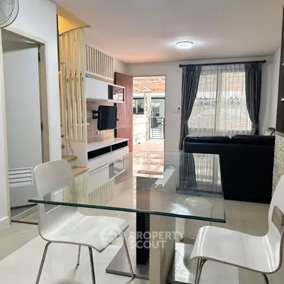 Modern living room with glass dining table and stylish decor
