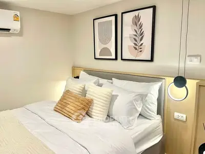 Modern bedroom with stylish decor and cozy bedding in a contemporary apartment.