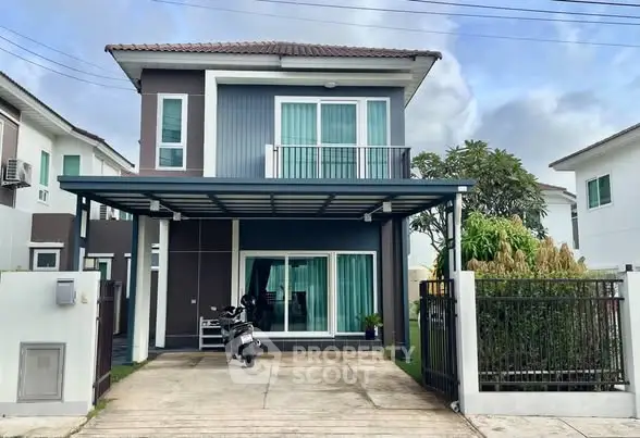 Modern two-story house with a carport and well-maintained exterior in a suburban neighborhood.