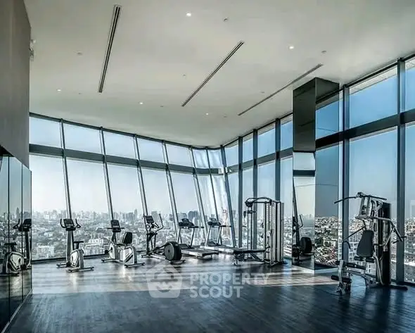 Luxurious high-rise gym with panoramic city views and modern fitness equipment.