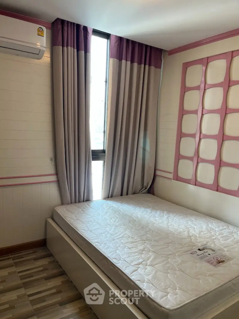 Cozy bedroom with natural light and modern decor, featuring a comfortable mattress and stylish curtains.