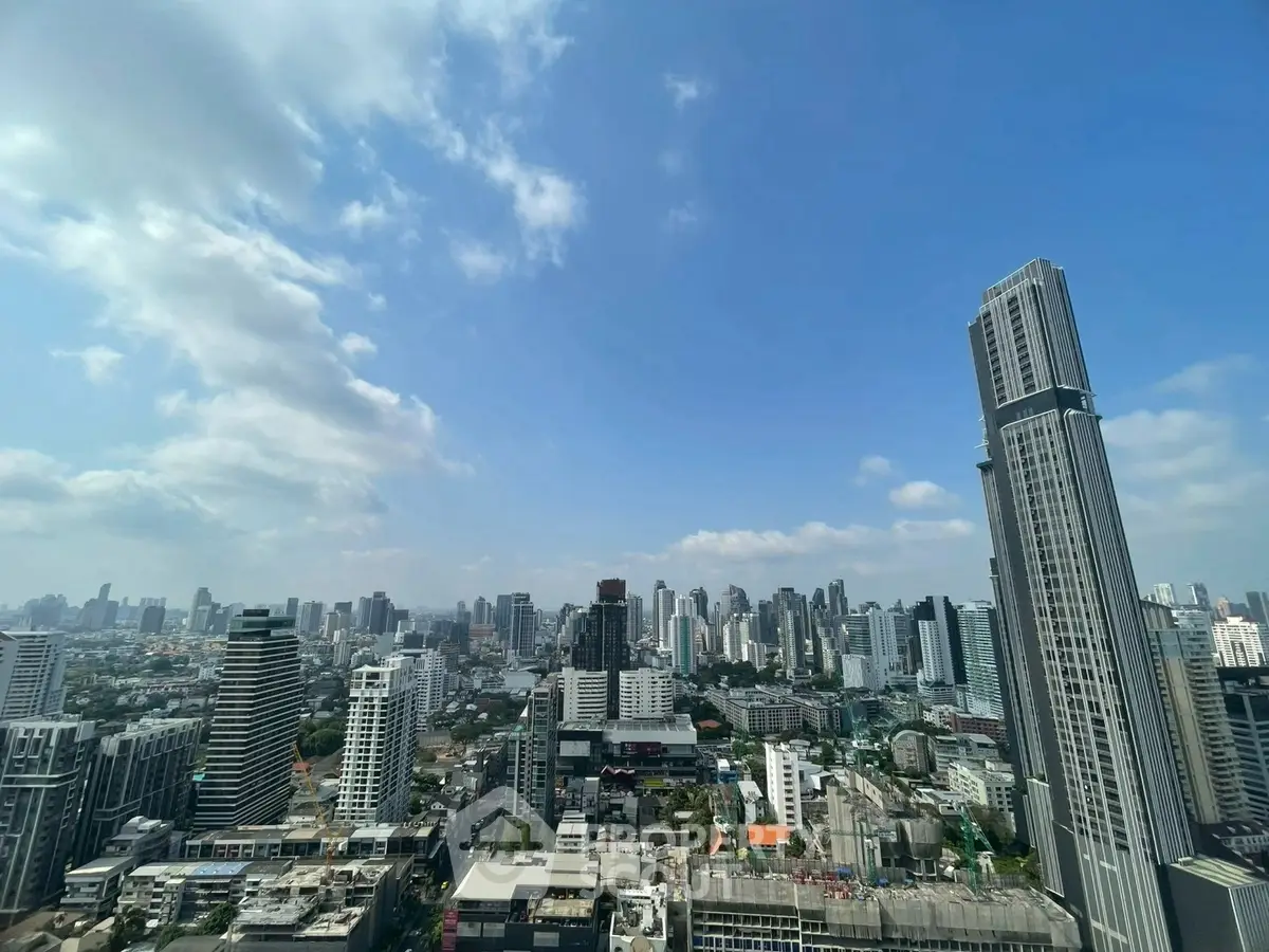 Stunning cityscape view from a high-rise building showcasing urban skyline and architecture.