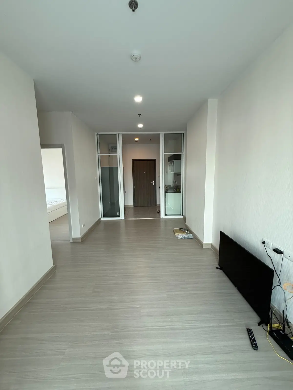 Spacious modern apartment with sleek flooring and open layout, ideal for contemporary living.