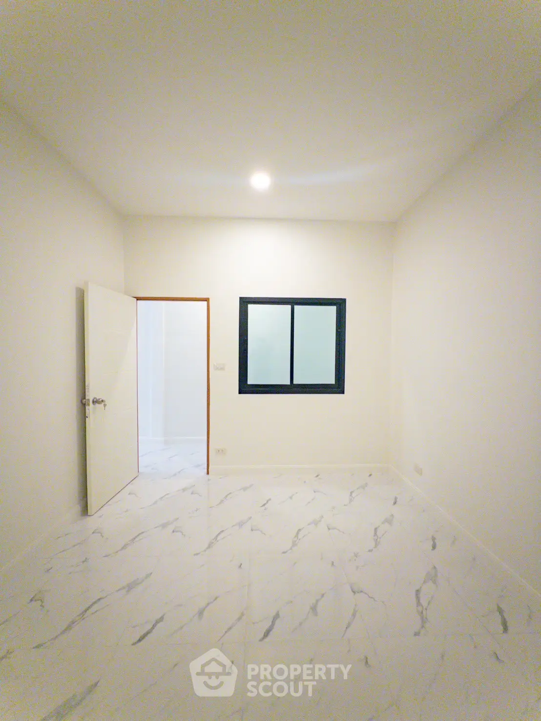 Minimalist empty room with marble flooring and window, ready for customization.