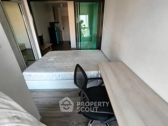 Compact bedroom with desk and chair, ideal for efficient living.