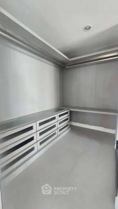 Spacious storage room with modern shelving and ample space.