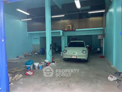 Spacious garage with car and storage potential in vibrant blue interior