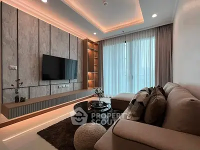 Modern living room with stylish decor, cozy sofa, and large TV, perfect for relaxation and entertainment.