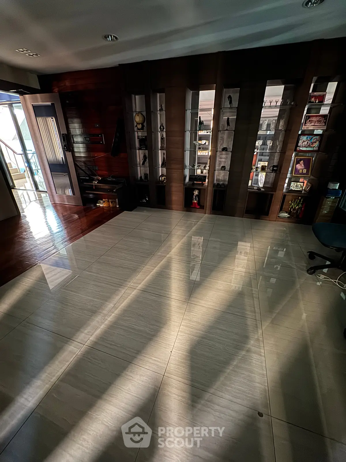 Spacious modern living room with elegant wooden accents and ample natural light.