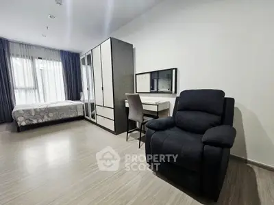 Spacious bedroom with modern furniture and ample natural light