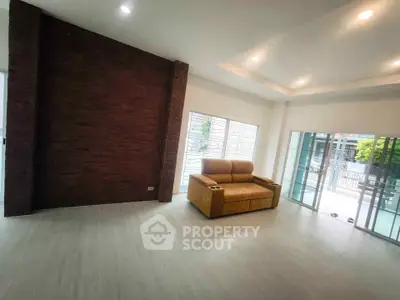 Spacious modern living room with large windows and cozy seating