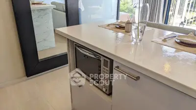 Modern kitchen island with built-in microwave and elegant dining setup