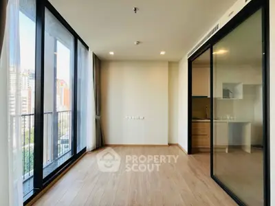 Spacious modern living room with large windows and balcony view