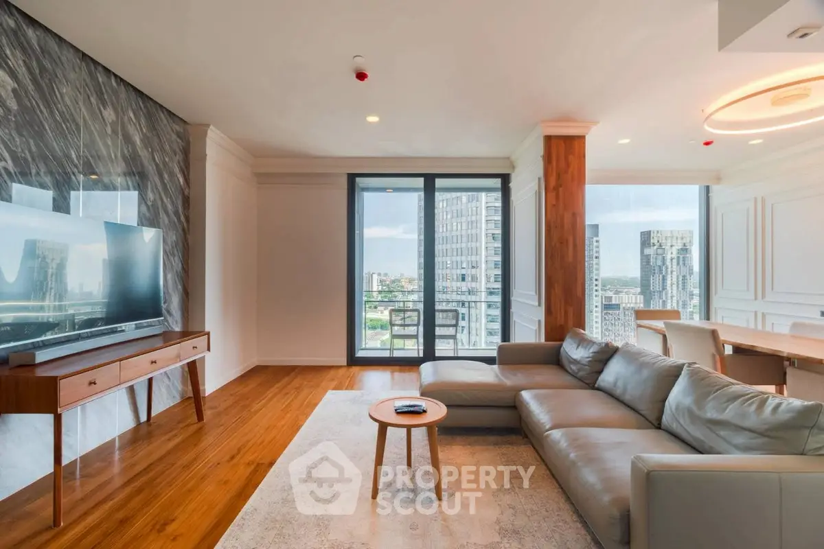 Luxurious modern living room with sleek furniture and stunning city view from large windows.