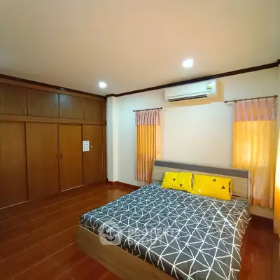 Spacious bedroom with modern design and ample storage space.