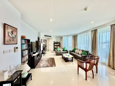 Spacious and elegant living room with large windows and modern decor