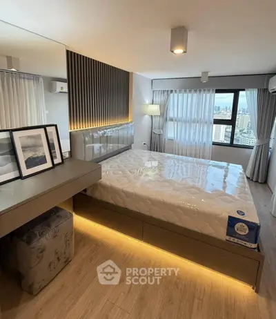 Modern bedroom with city view, featuring stylish decor and ambient lighting.