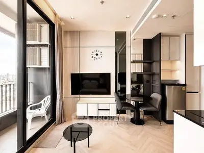 Modern living room with balcony view, sleek furniture, and stylish decor in urban apartment.