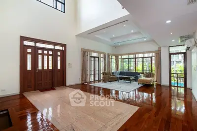 Spacious living room with elegant wooden flooring and large windows