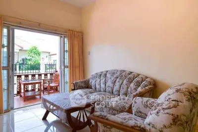 Cozy living room with elegant sofa set and open balcony view
