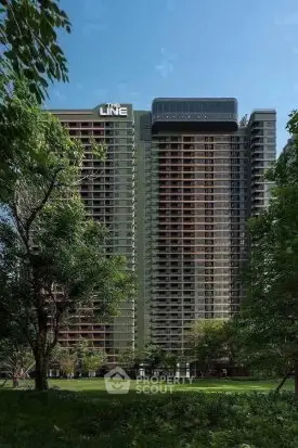 Stunning high-rise building with lush greenery, perfect for urban living with nature's touch.