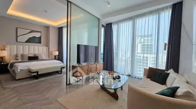 Luxurious modern bedroom with stylish living area and floor-to-ceiling windows offering city views.