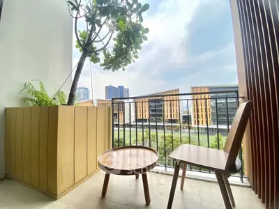 Charming balcony with modern furniture and city view, perfect for relaxation.