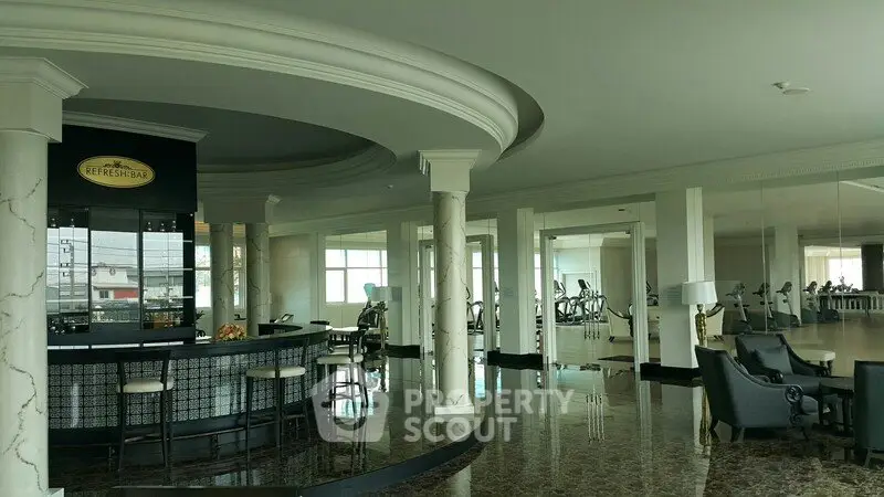 Luxurious gym and refreshment bar in modern residential building with elegant marble flooring and panoramic windows.