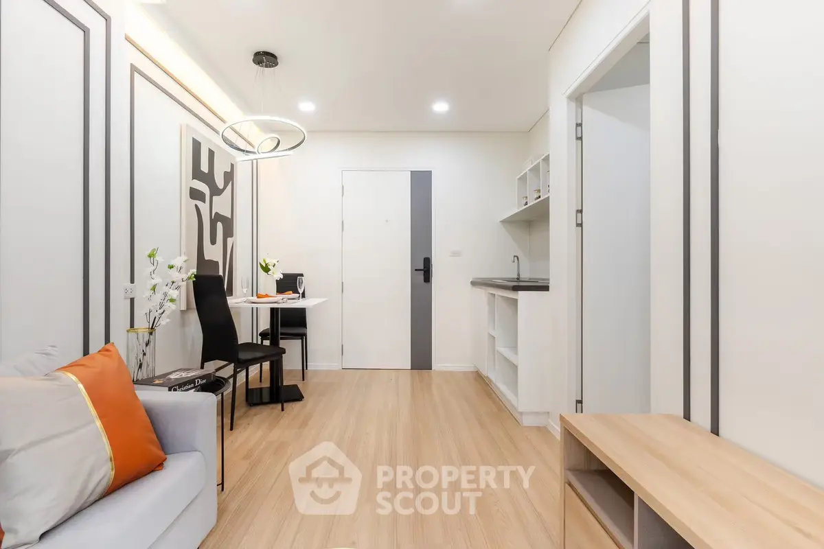 Modern living room with sleek design and cozy ambiance, featuring stylish furniture and contemporary lighting.