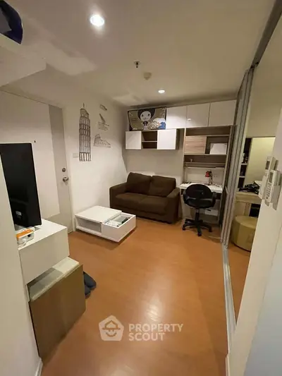 Cozy living room with modern decor and workspace in compact apartment