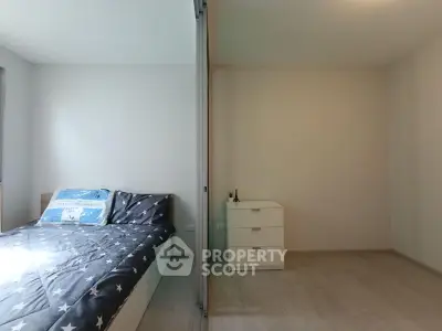 Spacious bedroom with modern decor and ample natural light