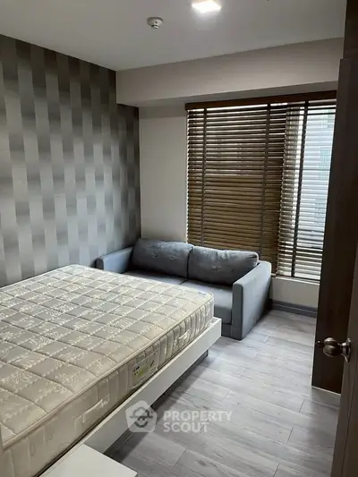 Modern bedroom with stylish decor and natural light