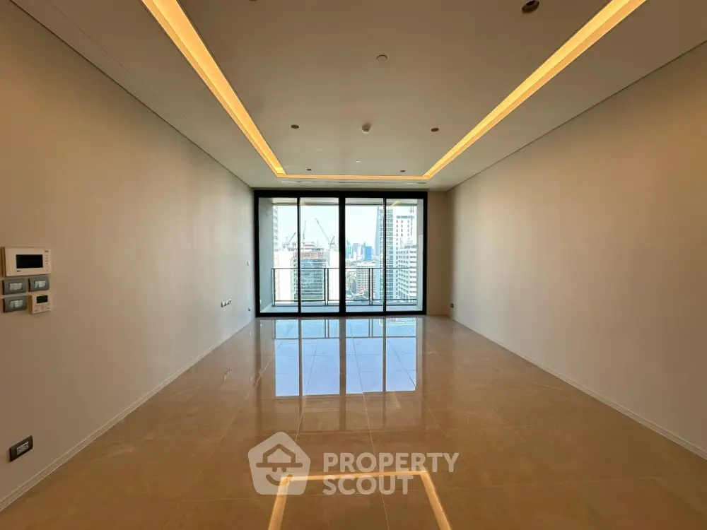 Spacious modern living room with city view and large windows in high-rise apartment.