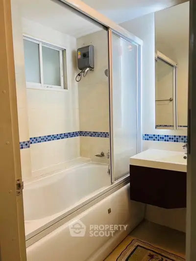 Modern bathroom with bathtub and sleek vanity in a stylish apartment.