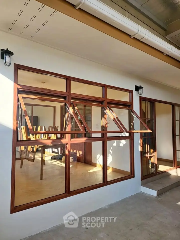 Modern home exterior with large windows and inviting interior view