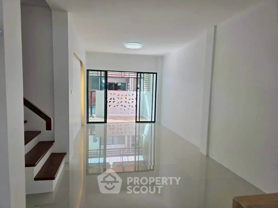 Spacious modern living room with glossy floors and large windows