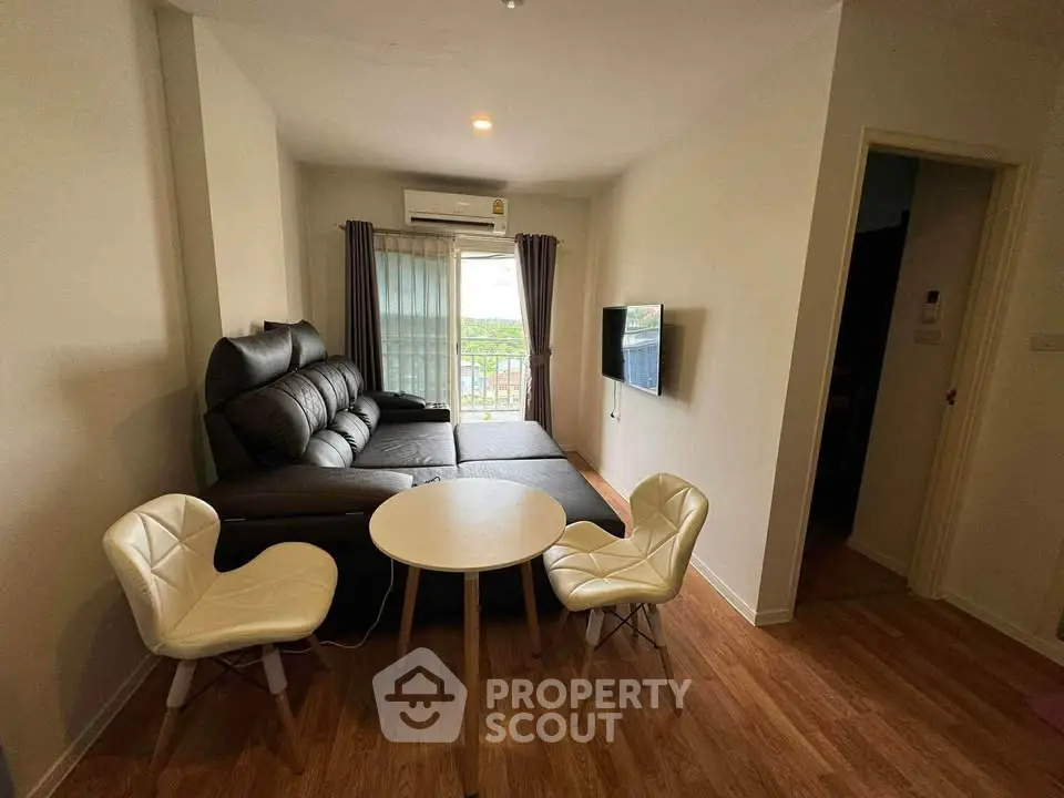 Modern living room with stylish furniture and natural light, perfect for relaxation and entertainment.