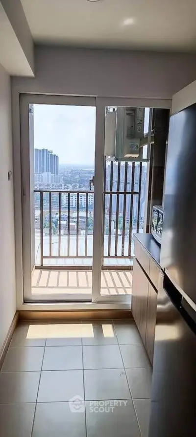 Modern kitchen with balcony view in high-rise apartment