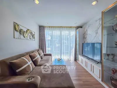 Modern living room with elegant decor and large sofa, featuring floor-to-ceiling windows for natural light.