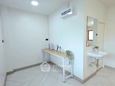 Minimalist study room with modern desk and wall-mounted sink