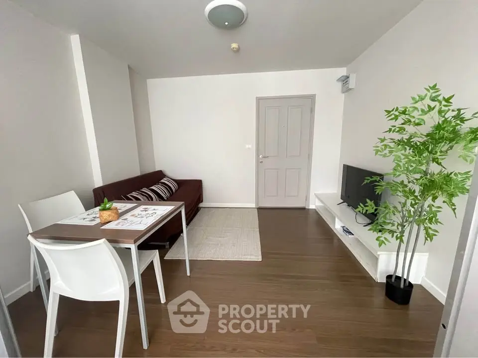 Modern living room with sleek furniture and wooden flooring, perfect for cozy gatherings.