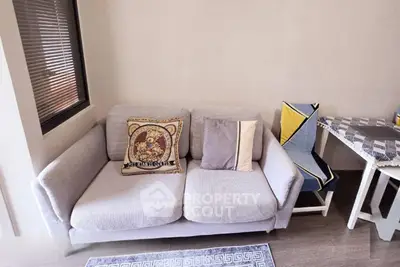 Cozy living room with modern sofa and stylish decor in a bright apartment.