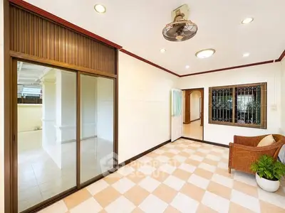 Spacious interior with sliding doors and checkered flooring, ideal for modern living.